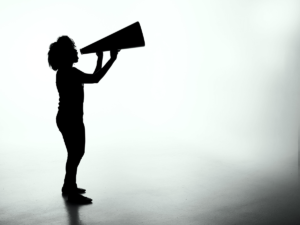 Woman sharing news stories through megaphone