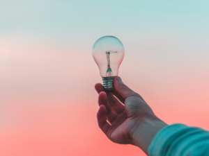 Image of a lightbulb held up to the sky